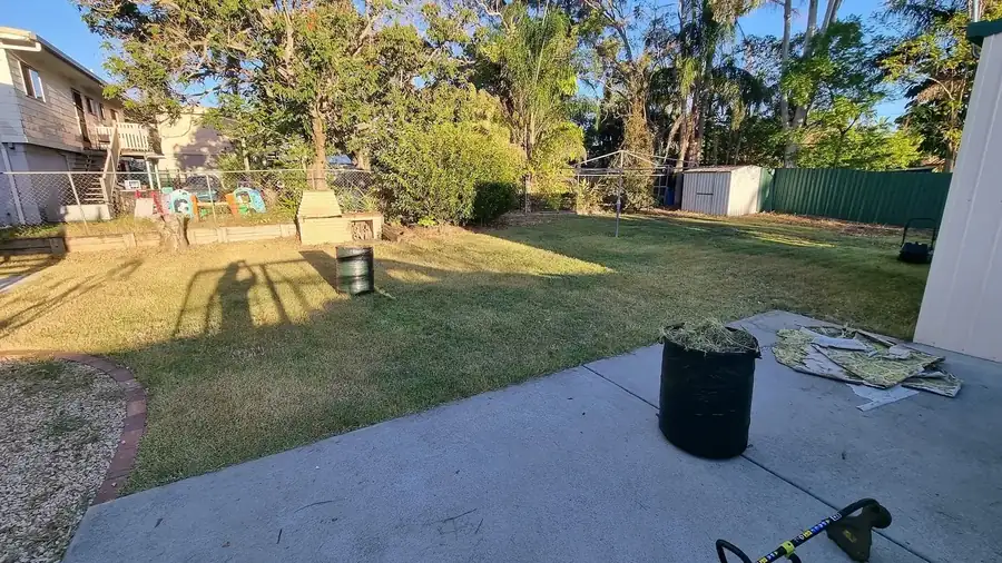 OnTime Landscape & Tree Maintenance carrying out lawn mowing work in Logan Reserve